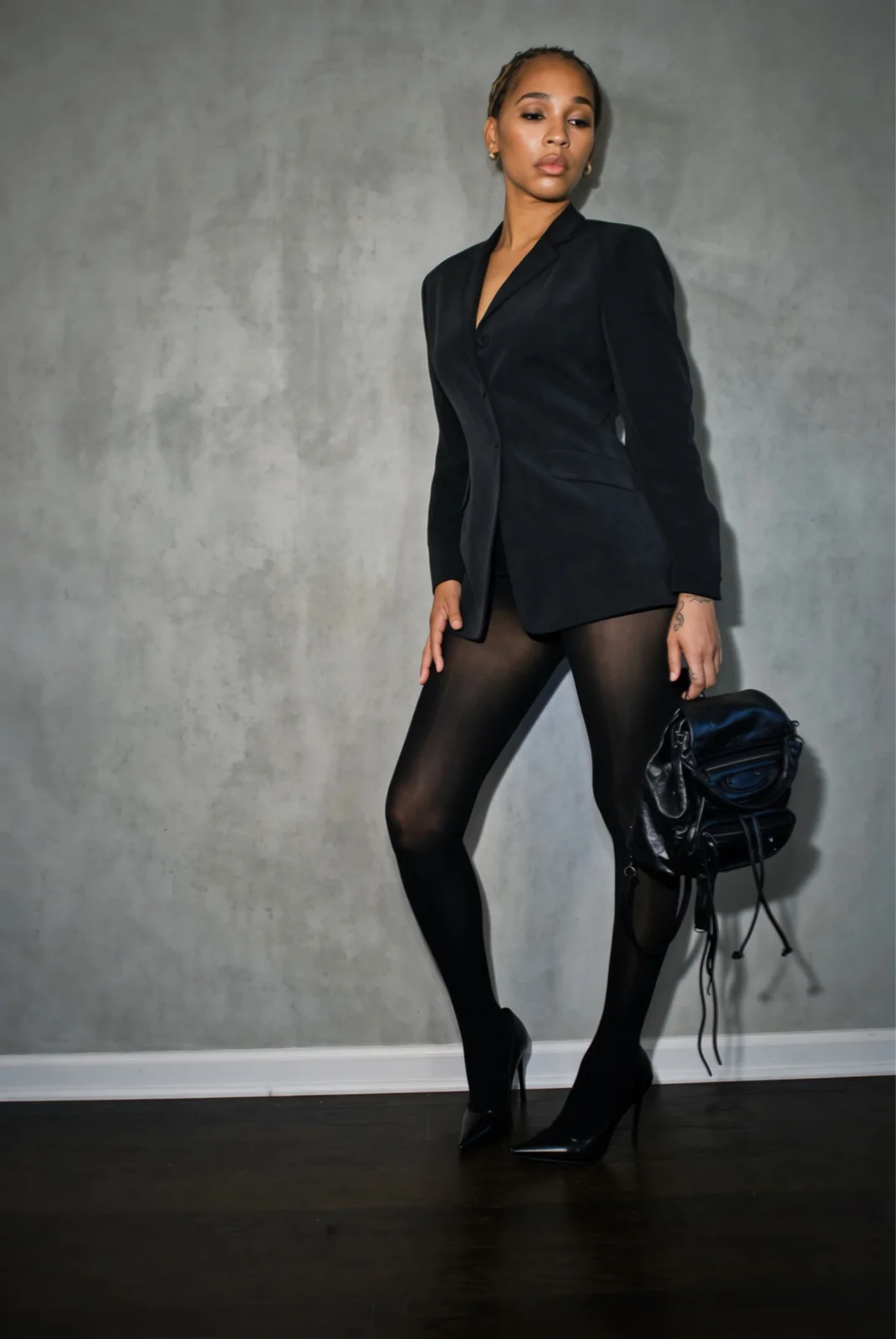 Black tailored blazer worn as a mini dress with pointed stilettos
