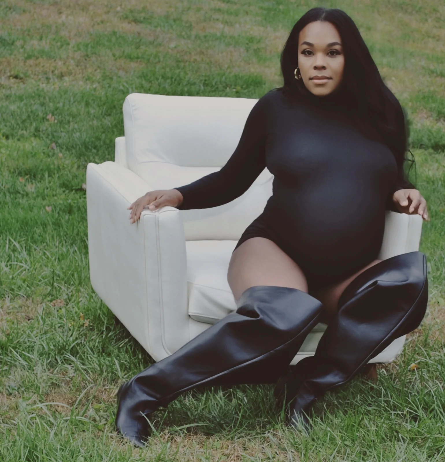 Black maternity bodysuit with slouchy over-the-knee leather boots